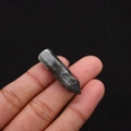 Macro shot of a polished hexagonal natural crystal point with grey and black mottled patterns - 8x33mm / Grey Black Pattern