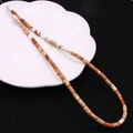 Cylindrical 4x8mm natural stone beads in mixed earth tones on a white decorative plate - 4x8mm / Beige Mixed (No.3)
