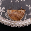 Detailed view of D-shaped natural picture stone pendant with gold plated double rings - Jasper