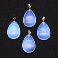Close-up of four opal teardrop pendants with silver bails on black velvet background - 18x25mm / Opal