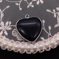 Detailopname van een hartvormige zwarte agaat hanger met zilveren rand en oogje - 26x28mm, 7g / Zwarte agaat