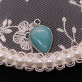 Teardrop turquoise pendant with silver frame on lace background for DIY necklace making - Amazonite