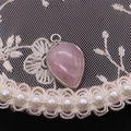 Elegant teardrop rose quartz pendant with silver plated metal edge on lace background - Rose Quartz