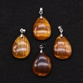 Tiger Eye teardrop pendants with golden brown stripes and cat-eye effect on black background - 18x25mm / Tiger's Eye