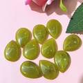 Detailed view of ten green water-drop natural stone cabochons for DIY jewelry making - 17x24mm / Peridot