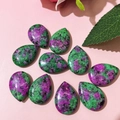 Detailed macro view of ten polished teardrop Ruby in Zoisite gemstones for DIY jewelry making - 17x24mm / Ruby Zoisite