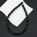 Macro detail of dark green tiger eye beads showing cat-eye effect for DIY jewelry - Green (No. 7)
