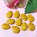 Flat lay of ten pear-shaped yellow jasper stones for DIY jewelry making and design - 17x24mm / Yellow Stone