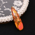 Macro detail of tear-drop imperial stone pendant with vibrant colorful texture and top hole - Orange Red Yellow Green Mottled (No. 2)