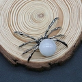 Spider shaped silver pendant with white pearl stone on a wooden display base - 34x47mm / White Jade