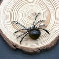 Silver spider pendant featuring a brown labradorite stone on a wooden background - 34x47mm / Tiger's Eye