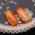 Detalle macro de cuentas de jaspe imperial naranja ovaladas con texturas naturales - 12x25mm / Amarillo Naranja (N.º 3)