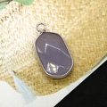 Macro detail of oval faceted purple picture stone pendant with silver plated metal rim - Grey Agate