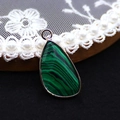 Close-up of teardrop malachite pendant with silver plating and green striped stone texture - 14x27mm / Malachite