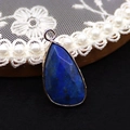 Macro detail of faceted blue natural stone pendant in gold-plated frame for jewelry DIY - 14x27mm / Lapis Lazuli