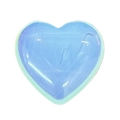 Close-up of heart-shaped opalite stone with smooth polished finish and blue glow - 20mm / Opal