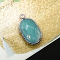 Oval turquoise-green natural stone pendant with silver plated edge and bail - Amazonite
