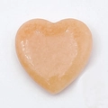 Close-up of polished peach heart-shaped natural stone bead for DIY jewelry making - 20mm / Rouge Jade