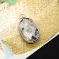Oval natural picture stone pendant with silver plated frame on woven background - Azurite
