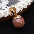 Pink stone teardrop pendant with gold metal bail clasp on a white lace doily - Strawberry Quartz (No. 1)