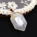 Grey hexagonal crystal pendant with gold foil inclusions and plated metal edging - Rutilated Quartz