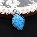 Detailed close-up of a blue natural stone rhombus pendant with a vintage silver metal frame - Blue Turquoise