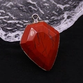 Macro detail of shield-cut red jasper stone pendant with natural black vein textures - Red Jasper