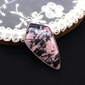 Detail view of pink spotted stone shield pendant with silver metal edging on lace - Pendant Only (No Chain) / Rhodonite with Black Lines