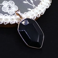 Shield shaped black gemstone pendant with faceted cut and gold plated metallic frame - Black Agate