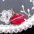 Macro detail of wire-wrapped red striped agate oval pendant with golden metal craft work - 14x21mm (3g) / Red Agate (No. 2)