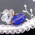 Macro view of blue agate stone pendant with intricate gold wire wrapping details - 14x21mm (3g) / Blue Agate (No. 5)