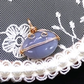 Macro shot of oval striped agate pendant with golden wire wrap and pearl accents - 14x21mm (3g) / Purple Grey Agate (No. 6)