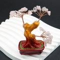 Macro shot of rose quartz crystal tree with copper branches in a red ceramic pot - Rose Quartz