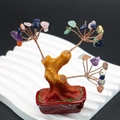 Close-up of handmade feng shui tree with natural crystals and copper wire branches - Colorful