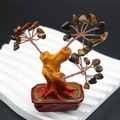 Detailed view of handmade tiger eye crystal money tree with copper wire and resin base - Tiger's Eye