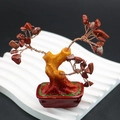 Macro detail of red gemstone money tree with copper wire branches and resin wood base - Red Jasper
