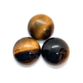 Macro detail of three natural tiger eye stone cabochons with engraved golden symbols - 4mm / Tiger's Eye