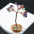 Detailed close-up of a handmade mini crystal life tree with colorful gemstones and copper wire - Colorful