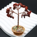 Detailed view of handmade crystal money tree with red gemstones and copper wire trunk - Red Jasper