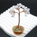 Detail of handcrafted wire-wrapped life tree with translucent stones and woven basket base - Opal