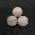 Polished rose quartz cabochons with engraved geometric symbols on a black texture - 16mm / Rose Quartz