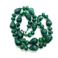 Green malachite beaded necklace with teardrop and round stones on a white background - Malachite