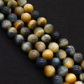 Macro shot of tiger eye beads with natural chatoyancy on black textured background - Yellow Blue Mixed (No.10)