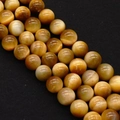 Macro detail of natural yellow tiger eye beads with polished texture for DIY jewelry making - Golden Yellow (No.6)