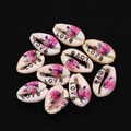Macro view of ten natural cowrie shells with floral prints and LOVE text for DIY jewelry - Pack of 20 (9x19mm) / Love Pattern (No. 2)