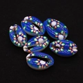 Close-up of six vibrant blue cowrie shell beads with colorful floral print for DIY jewelry - Royal Blue Tri-color Floral Style (No. 3)