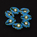 Macro detail of blue painted natural cowrie shells with geometric patterns for DIY jewelry - Bright Blue Star Geometric Style (No. 5)