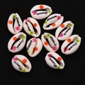 Macro detail of natural seashell beads with hand-painted flowers and 'dream' lettering - Pack of 20 (9x19mm) / Dream Pattern (No. 6)