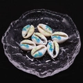 Detailed macro view of seven hand-painted natural cowrie shell beads for DIY jewelry making - Style 5 (Blue-Green Marine Life) / 20 Pieces Set