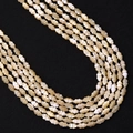 Macro shot of 5x8mm natural shell beads with pearlescent luster for DIY jewelry making - Natural